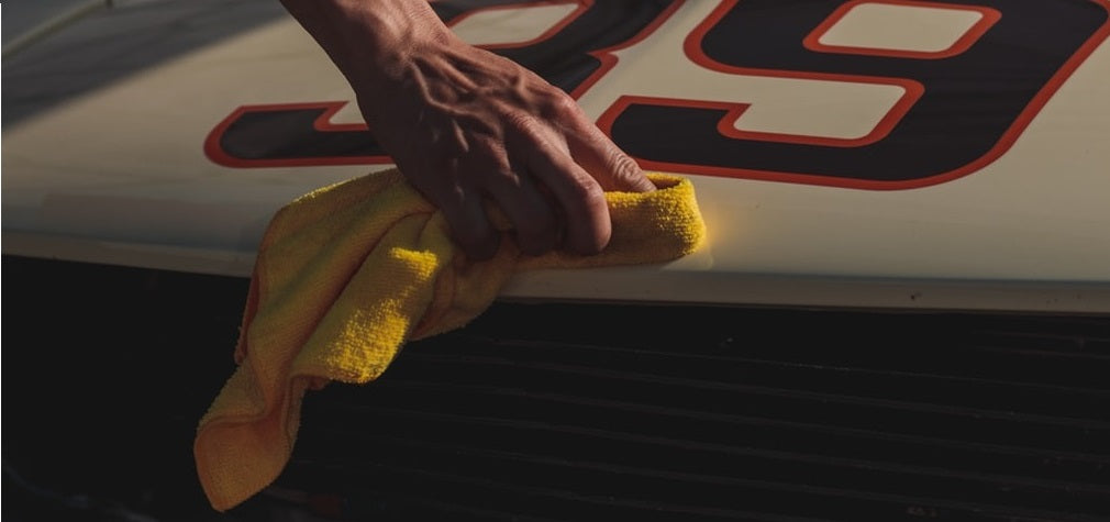 yellow microfiber towel polishing a NASCAR